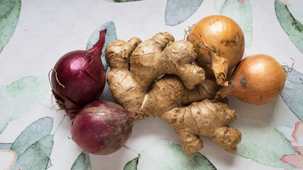 Ginger and onions on rustic background