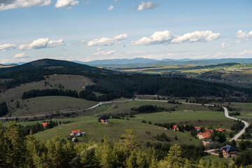 Fototapeta na wymiar Meandering mountain road leading to a mountain village. Top view of mountain road.