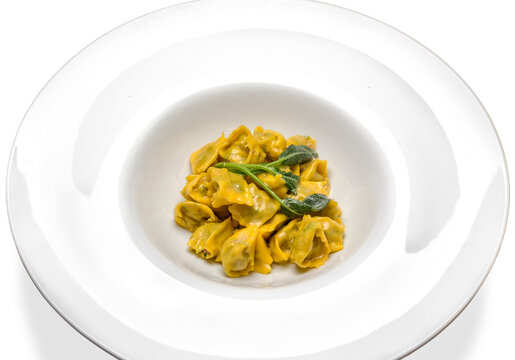 Agnolotti del plin typical Piedmontese filled ravioli pasta from the Langhe in Italy seasoned with butter and sage and parmesan