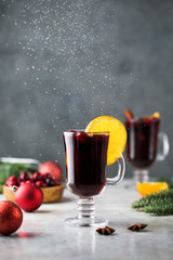  Hot mulled wine on a Christmas background with falling snow. Christmas concept.