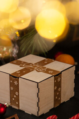 wooden box with an engraving of a bow and ribbon on the lid