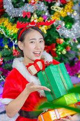 woman wearing christmas outfit holding gift video call