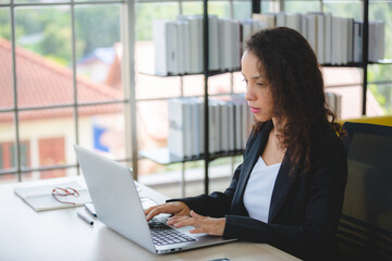 African American business freelance woman working at home with online communication using laptop