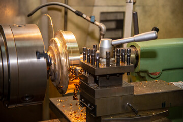 The lathe machine finishing cut the brass shaft parts by lathe tools.