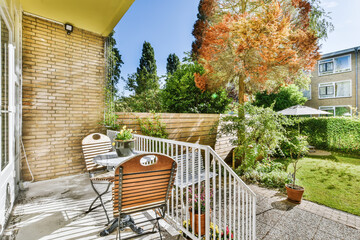 Cozy sunny veranda of the house with wooden chairs