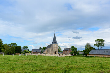The church of the traditional French village of Saint Sylvain in the middle of the fields in Europe, France, Normandy, towards Veules les Roses, in summer, on a sunny day.