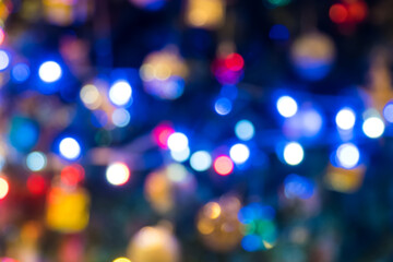 Colorful defocused bokeh lights in blur night background. Abstract circular bokeh background of Christmaslight