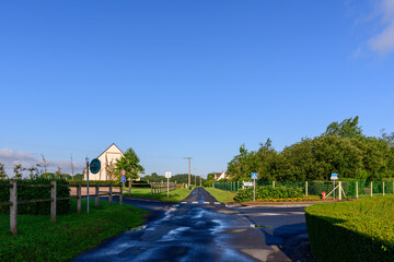 A road in the traditional French village of Saint Sylvain in Europe, France, Normandy, towards Veules les Roses, in summer, on a sunny day.