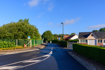 A road in the traditional French village of Saint Sylvain in Europe, France, Normandy, towards Veules les Roses, in summer, on a sunny day.