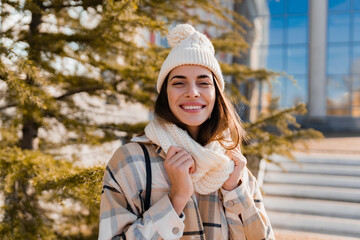 young smiling woman walking in street in winter