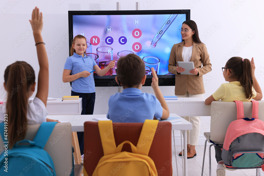 Sticker Teacher and pupil using interactive board in classroom during lesson