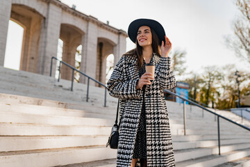 attractive young woman walking in autumn wearing coat