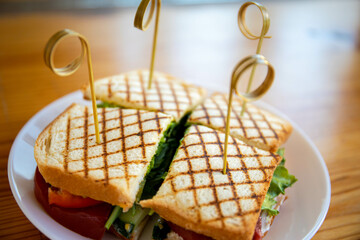 sandwich with chicken and herbs fried in the dough junk from which there are lettuce leaves...