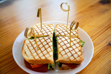 sandwich with chicken and herbs fried in the dough junk from which there are lettuce leaves...