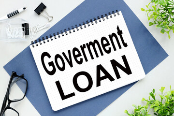 Goverment Loan. text on notepad on blue background