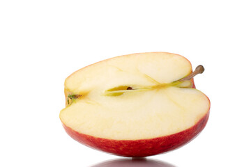 One half of an organic red apple, close-up, isolated on white.