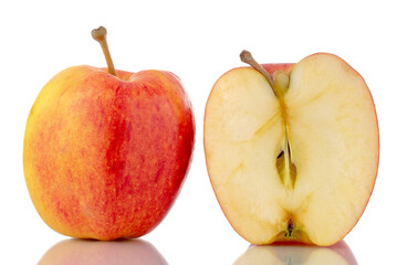 One half and one whole organic red apples, close-up, isolated on white.