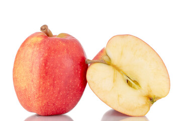 One half and one whole organic red apples, close-up, isolated on white.