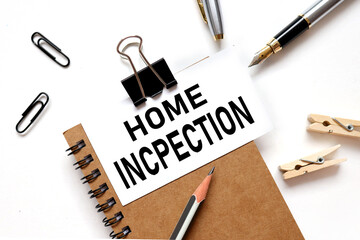 HOME INCPECTION. lettering on a business card on a notebook