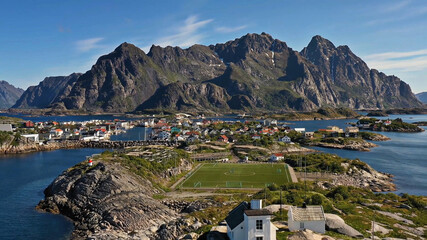 Amazing nature of Lofoten Islands, Norway By Drone top view stadium surrounded by norway lake green...