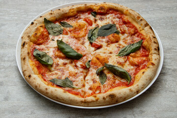 Pizza Margarita with leaves of basil