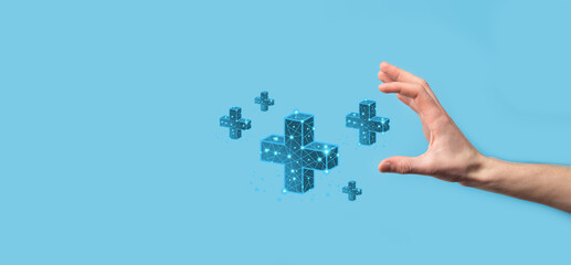 Businessman hand holding 3D plus low polygonal icon.Plus sign virtual means to offer positive thing...