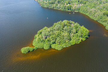 An island in the middle of Lac des Settons in Europe, France, Burgundy, Nievre, Morvan, in summer, on a sunny day.