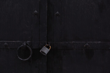 Padlock on an iron door.