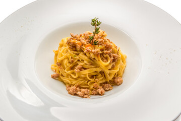 Piedmontese tajarin, tagliolini are a fresh egg pasta of the Langhe culinary tradition, seasoned with sausage ragù in a white dish