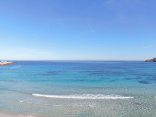 Cala Agulla Mallorca. Aerial view of the seacoast of the beach in Mallorca with torquoise water colour. Amazing photo of the beach. Concept of summer, travel, relax and holiday and vacation
