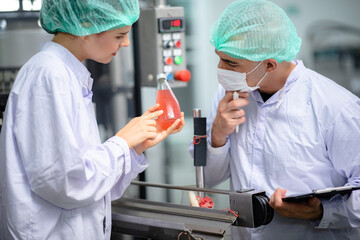 food technician control checking production line of water drink in manufacturing factory
