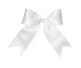Satin ribbon tied in bow on white background, top view