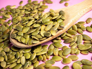 Pumpking seed on a wooden spoon.