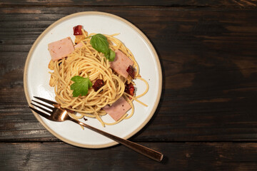 Pasta in white plate on wood background Italian food.