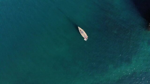 The sailing yacht is in the bay. Aerial view. Sunny day. Cinematic serene, calm and relaxing concept