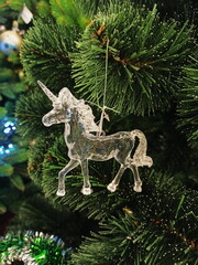 Christmas toy unicorn hanging on a Christmas tree 