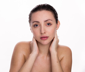 Beautiful face of young woman with clean fresh skin. Beauty portrait of brunette standing on white background copy space