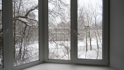 Interior of a room with a view of the winter landscape.