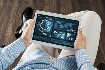 businessman with tablet on his lap