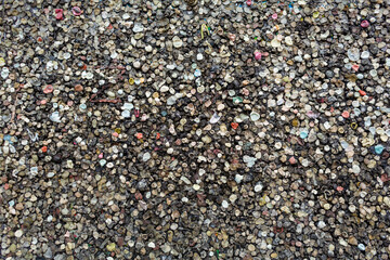 The texture of the landmark Berlin Wall is covered with chewing gum