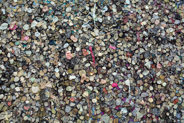 The texture of the landmark Berlin Wall is covered with chewing gum