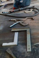 Obraz na płótnie Canvas the workplace of a locksmith welder with different tools