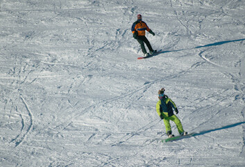 Fototapeta na wymiar Snowboarders on the snowy slope