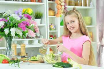 Cute girl preparing delicious fresh salad