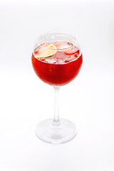 Cocktail in a tall glass transparent glass - red colored drink with fruit orange. Delicious drink, healthy food, isolated