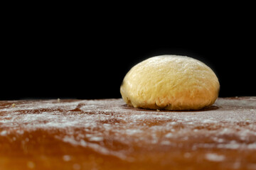 dough for pasta in a bun resting in flour