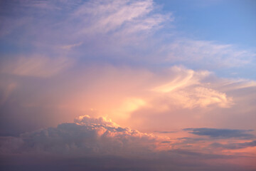 Colorful evening landscape with soft pastel coloured cloudscape on watercolor tinted sunset sky. Abstract nature background