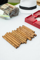 Multiple Hand Rolled Cigars on White Table
