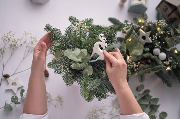 Workshop Master class handmade a Christmas table decoration. Hands close-up. Christmas decor made...