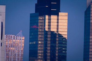 Warsaw, Poland. 30 october 2021. Skyscraper, modern building in the city with sunlight. Beautiful light at dawn. Reflection in glass